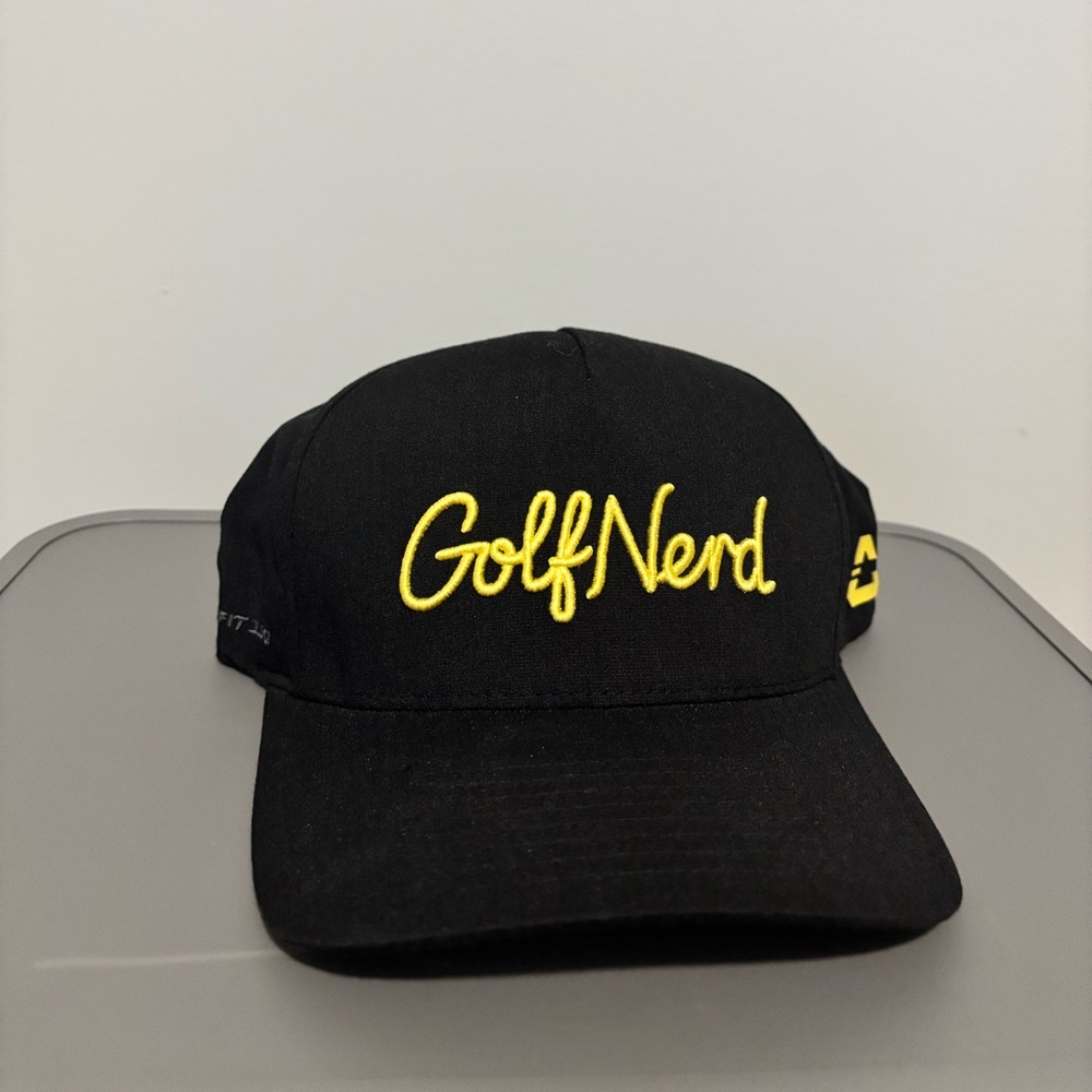 Travis Mathew Black Cap with Yellow 'GolfNerd' Embroidery